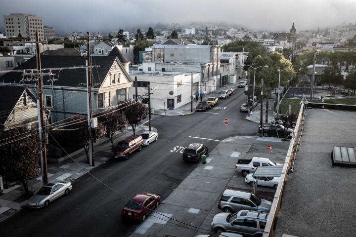 View from the top of building looking down at a city street.