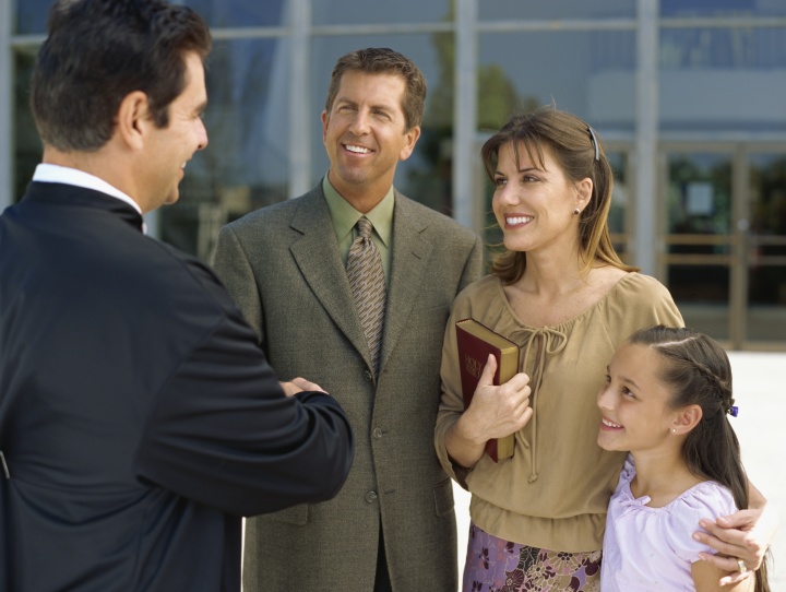 A family being greeted by others.