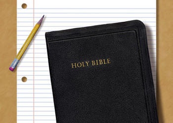 Bible with notepaper and pencil