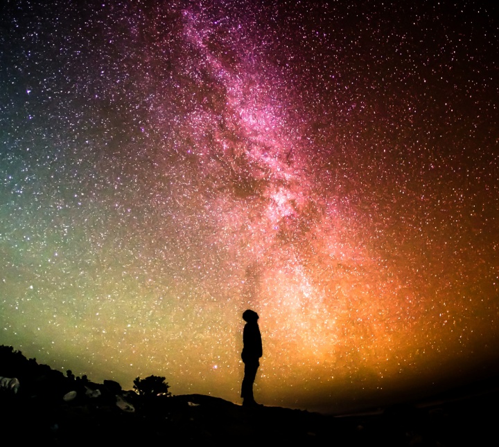 A person looking up at the millions of stars filling the night sky.