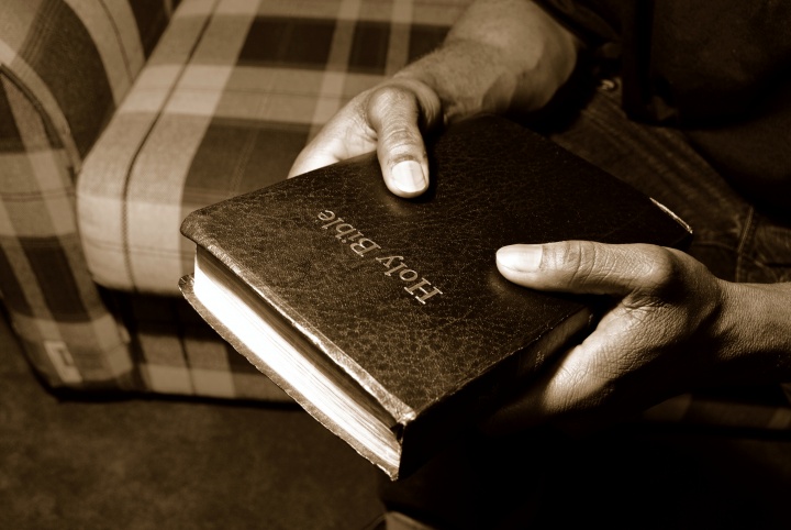 A man holding a Bible.