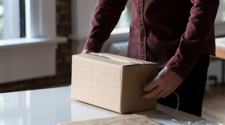 A man packaging a box.