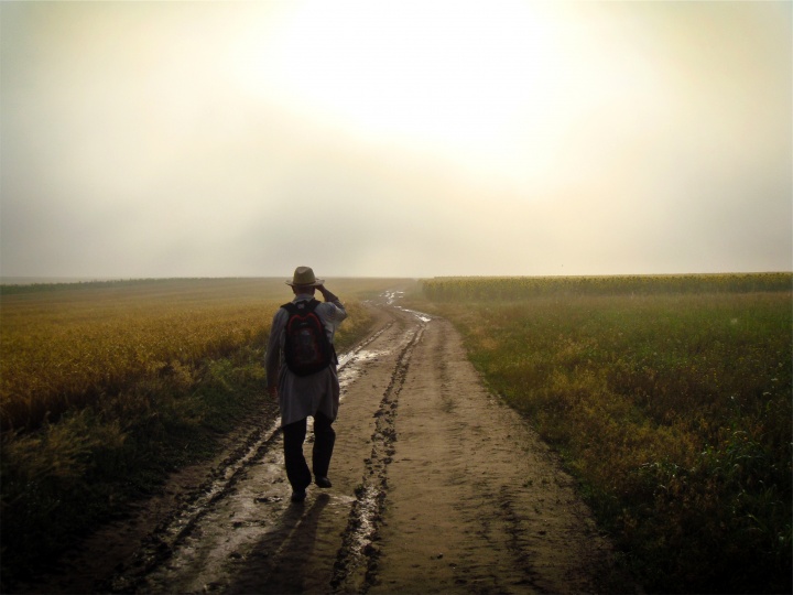 A man walking on a dirt path.