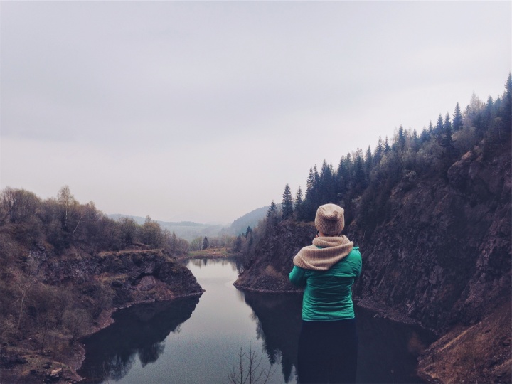 A young woman looking over a lake.