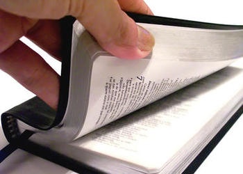 hand opening Bible