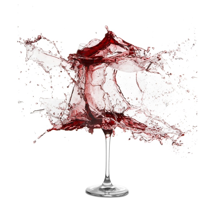 A wine glass exploding with wine.