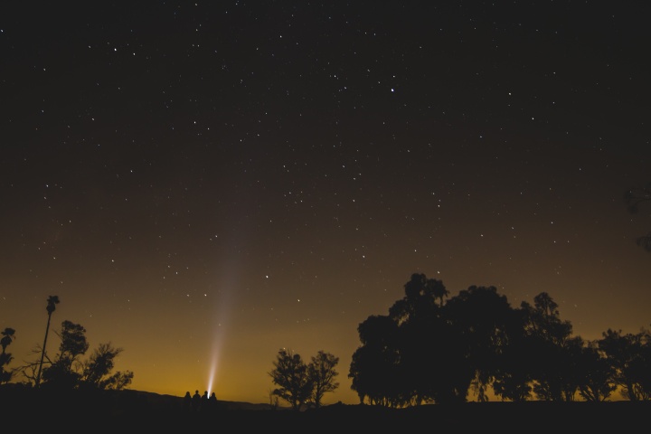 People sitting outside looking up at the stars.