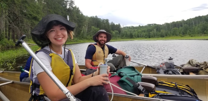 Photo of two campers in a canoe.