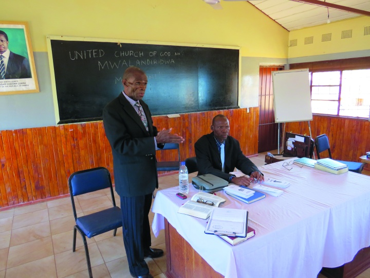 Filius Jere speaking and Nawa Talama sitting.