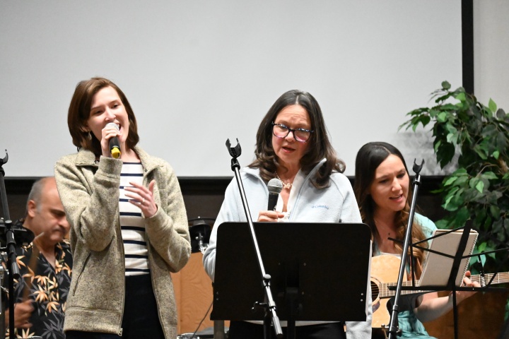 a group of three women singing