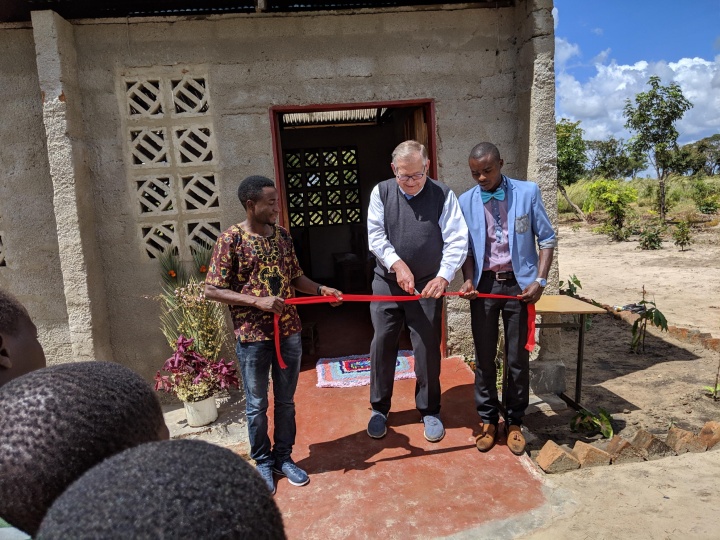 Mr. Kubik cuts the ribbon at the ceremony.