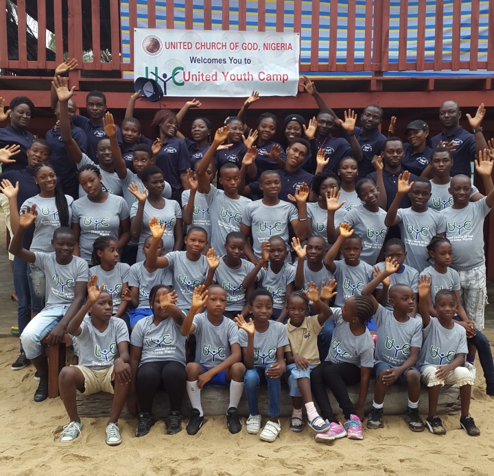 Campers and staff pose and wave at the camera. 