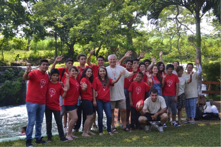 Campers pose and wave at the camera with Mr. Seiglie.