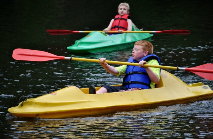 Campers canoe on the river at Camp Tomahawk.