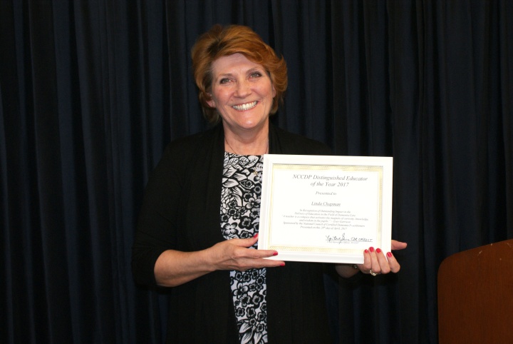 Linda “Andi” Chapman holding her “Educator of the Year” award. 