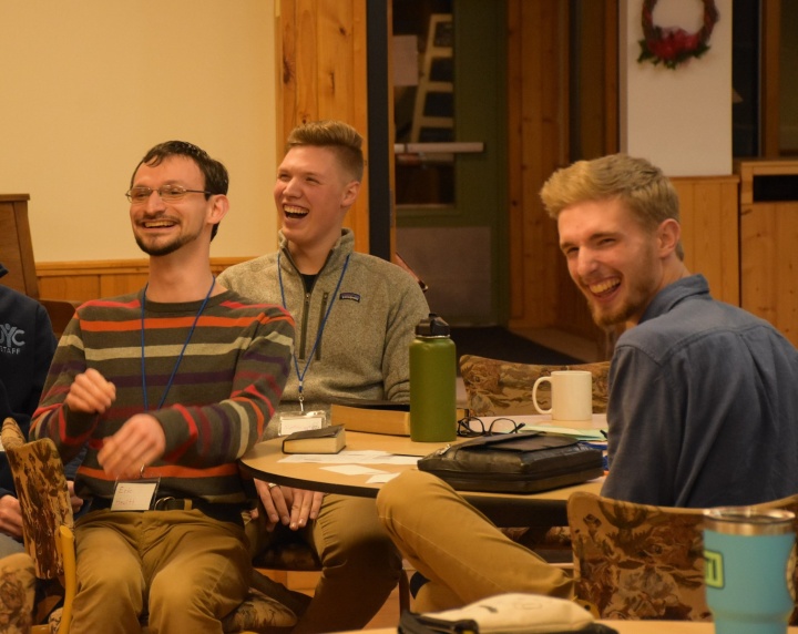 a group of three young men laughing