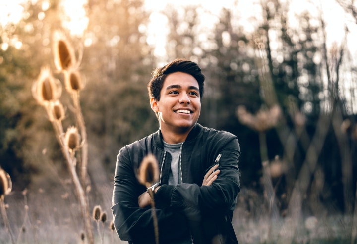 smiling man standing in a field