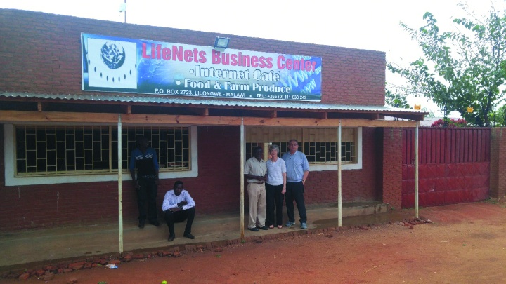 Victor and Bev Kubik stand with Joseph Mughogho, the LifeNets Business and finance manager in Malawi. The building they are standing in front of is the LifeNets Internet Cafe and grocery store.
