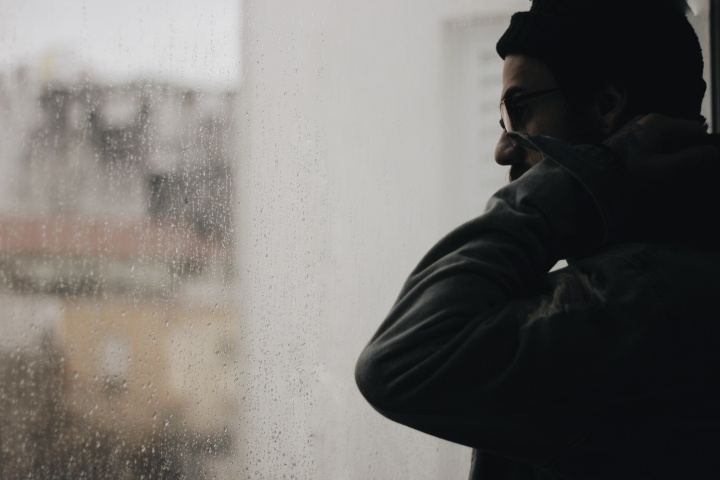 A man looking out a window.