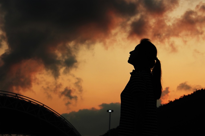 A woman looking up to the sky.