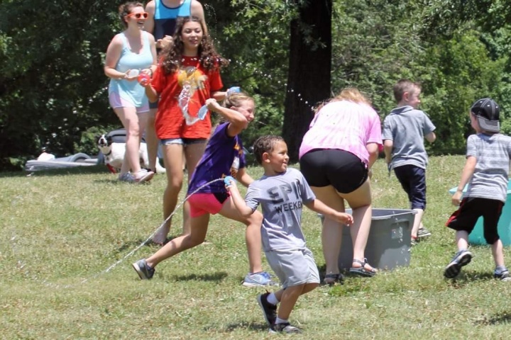 Members having a fun water balloon fight.