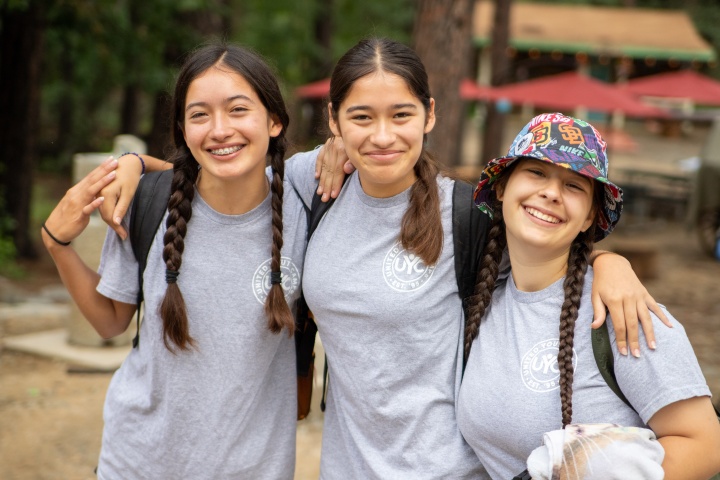 Three girls wearing UYC shirts