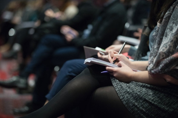 Photo of woman taking notes during church services.