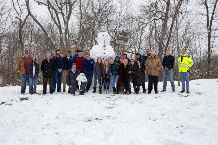 ABC students and staff pose with a snowman they made on Feb. 9.