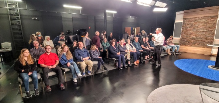 Peter Eddington arranges the studio audience before the recording of a Beyond Today television program.