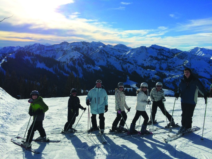 In this photos skiers pose in front of a magnificent view of mountains. Visitors from various parts of the U.S. came to Utah for the Salt Lake City Ski Weekend.