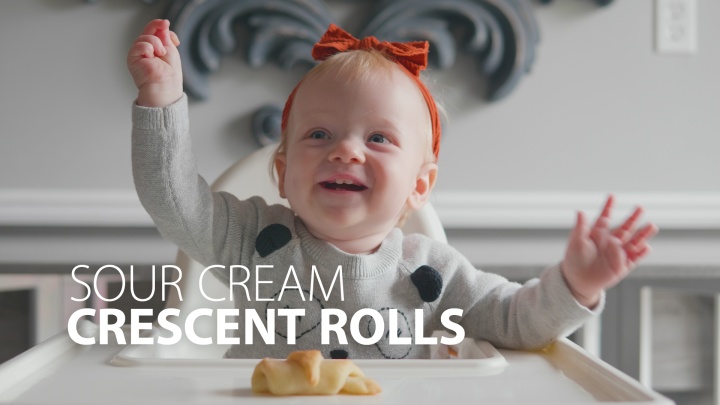 This is a photo of a baby holding the crescent roll.