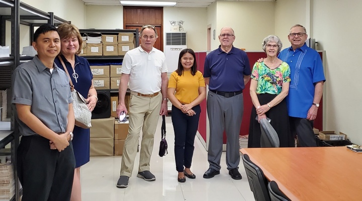 Inside the Philippines office: Richard Macaraeg, Debbie and Darris McNeely, Stella Cambare, David Dobson, Bev and Vic Kubik.