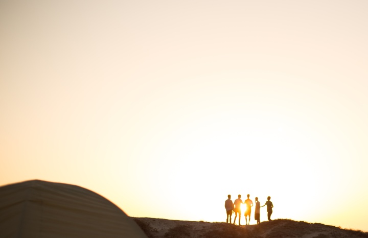 Photo of people's silhouettes at golden hour.