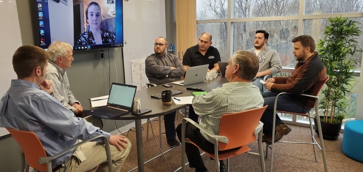 Our Web development team, joined by home office management, discussing how to best cover the many tasks Tom Disher was responsible for until a replacement for him can be found. (From left to right: Chris Stewart, Richard Kennebeck, Melanie May via Skype)