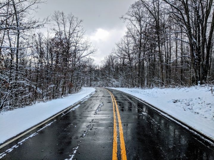 a road with a snowy landscape on either side