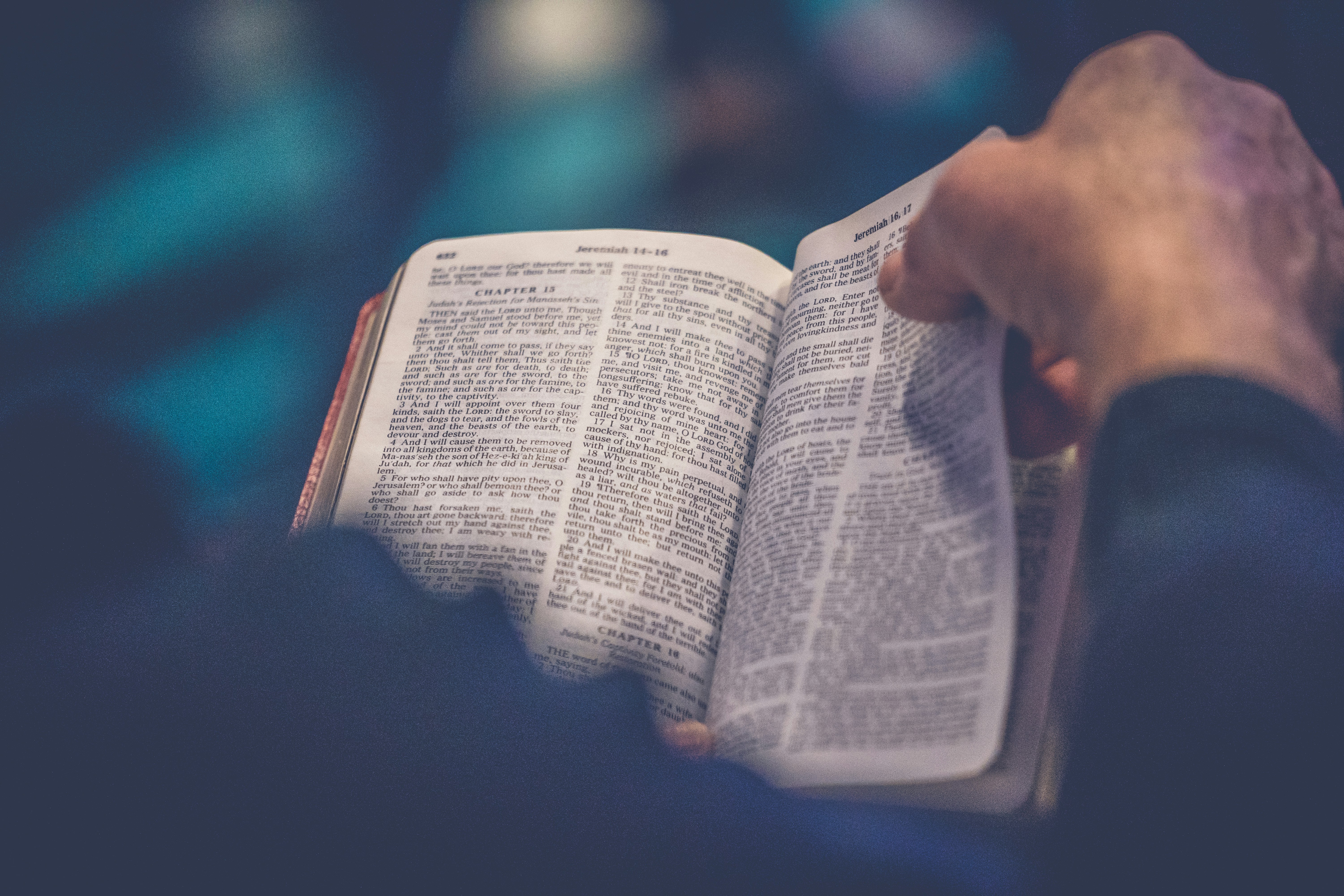 a person reading an open Bible