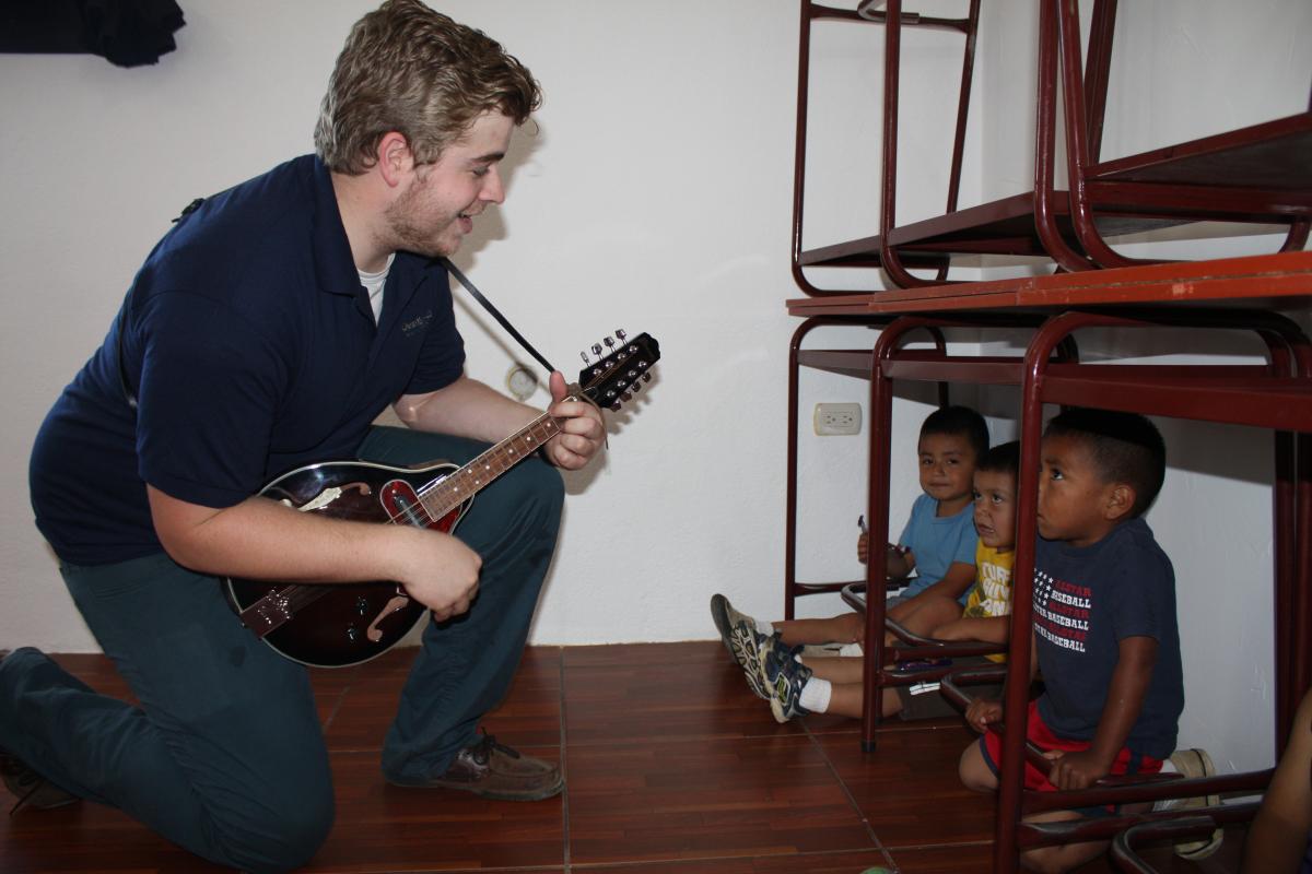 Garrett playing music for the Kids