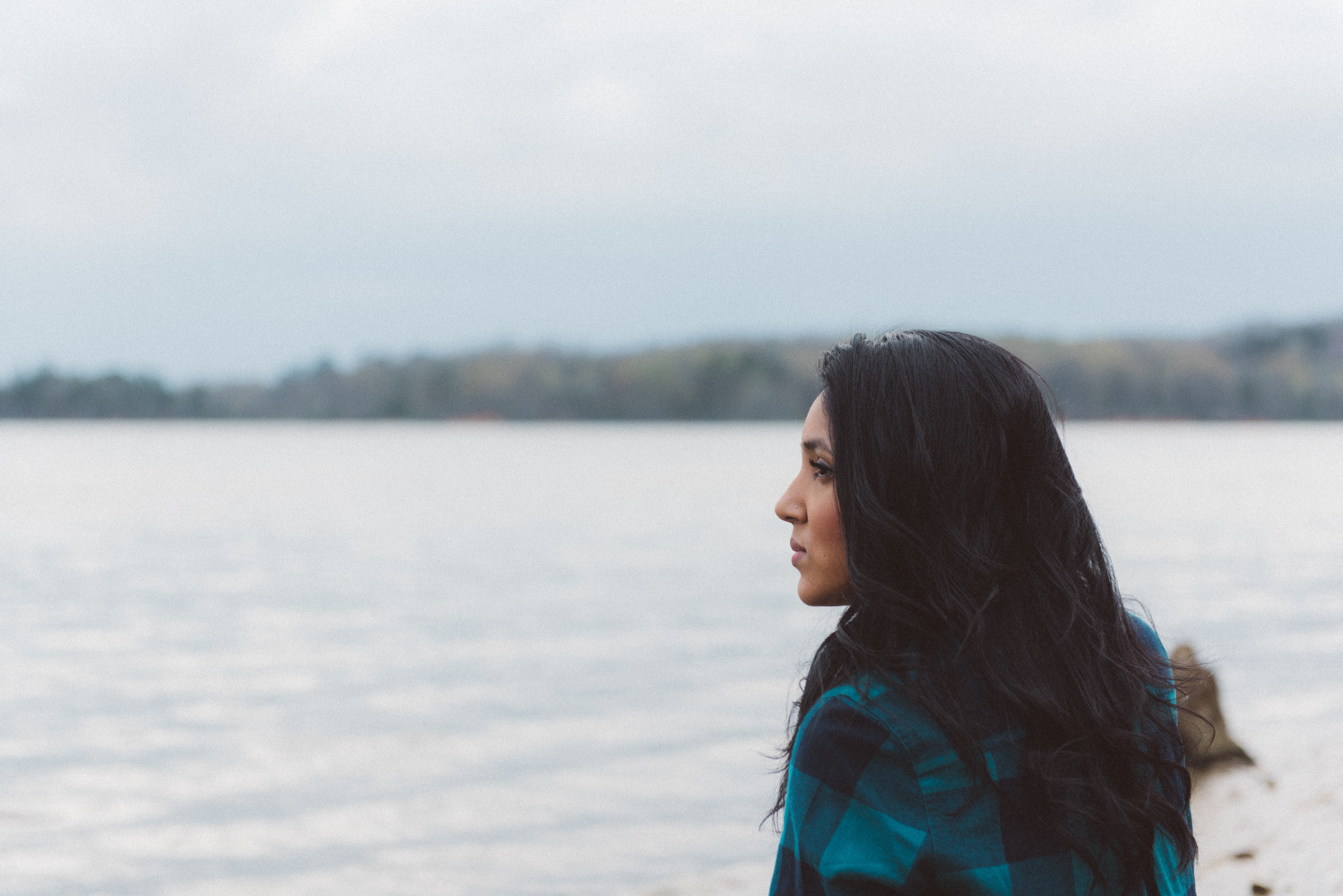 A woman looking over water.