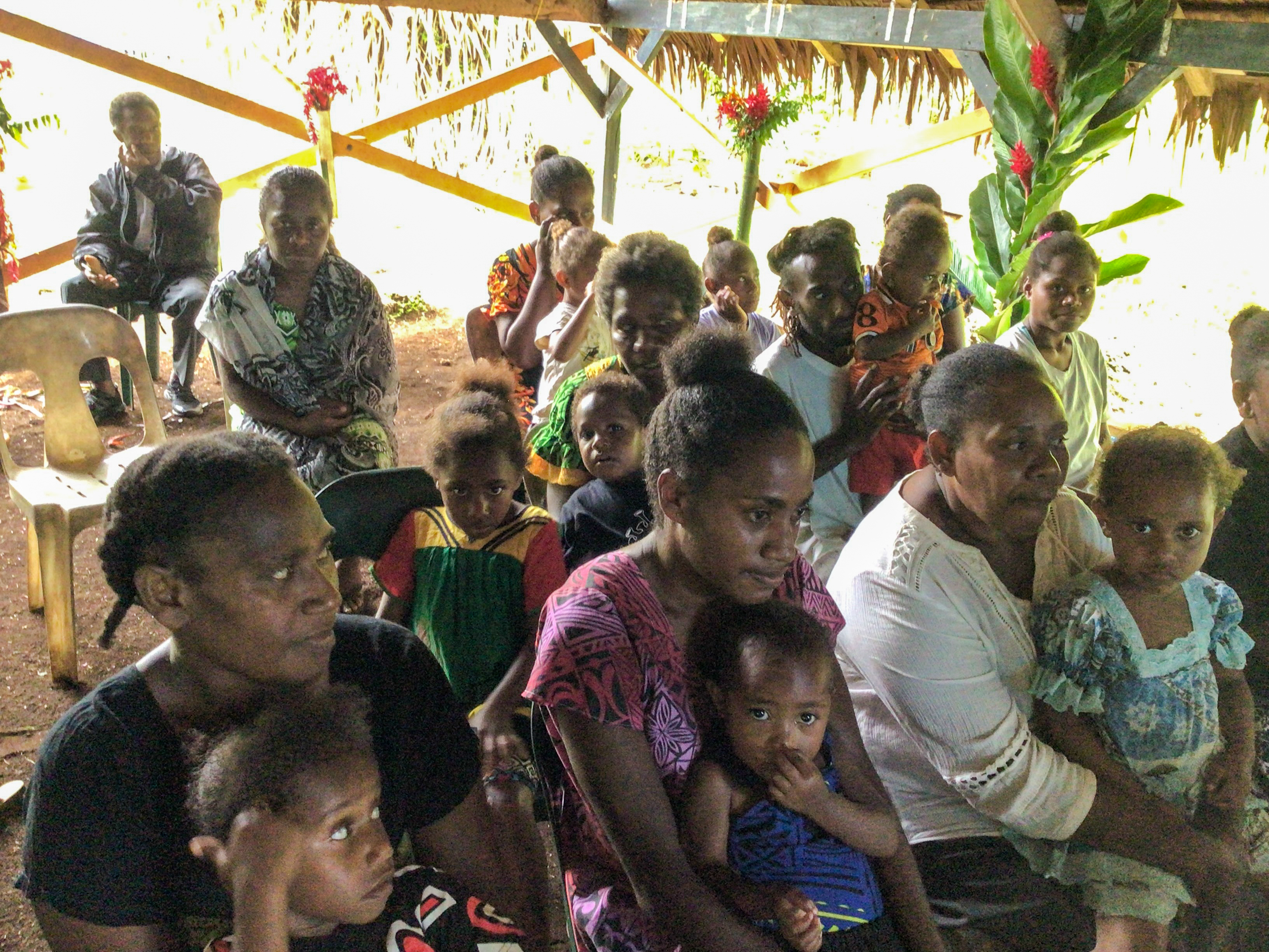 A group of parents and children gather for the Blessing of the Children ceremony in Vanuatu. a group of parents and children