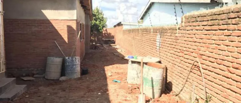 Undeveloped area between a building and a wall