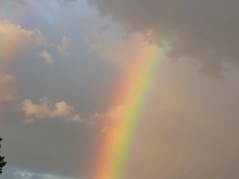 a rainbow in a cloudy sky