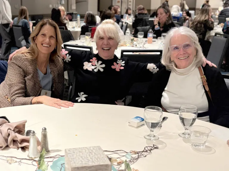 three women seated at a table