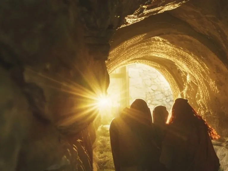 three silhouettes of people in a stone tunnel with a light at the end