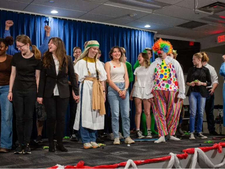 ABC Charity Auction a group of people in costume on a stage