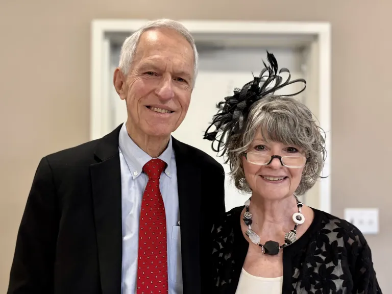 Husband and wife smiling at camera