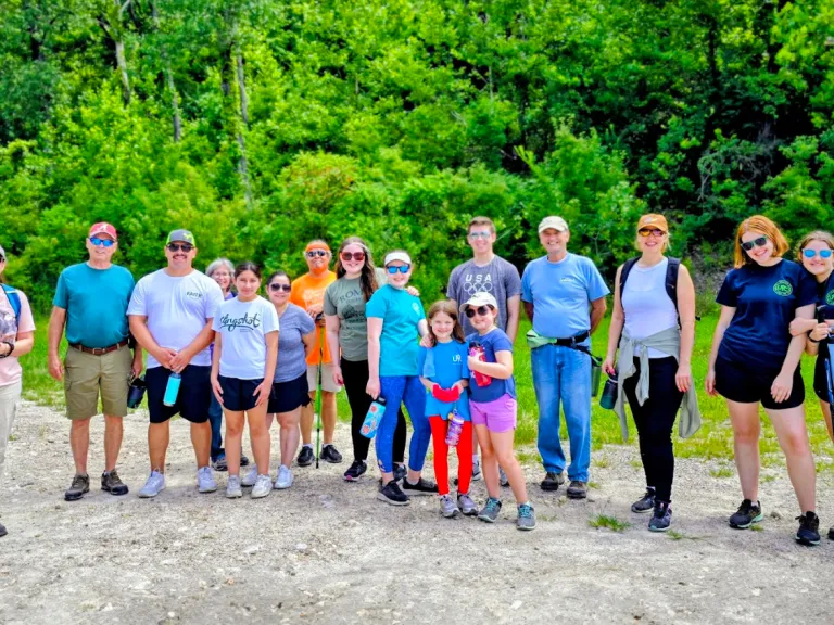 a group of people with hiking gear gathered for a photo