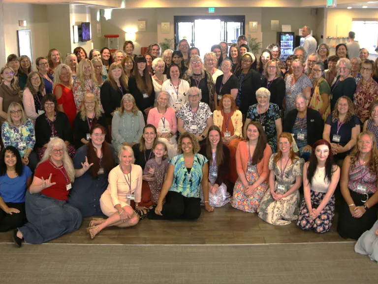 a large group of women gathered indoors