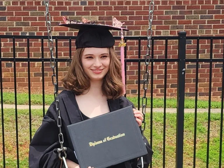 a young woman with a graduation hat and diploma
