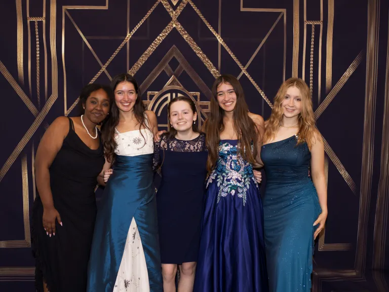 The “Vintage Hollywood”-themed prom was attended by 70 teens. five teenage girls wearing prom dresses