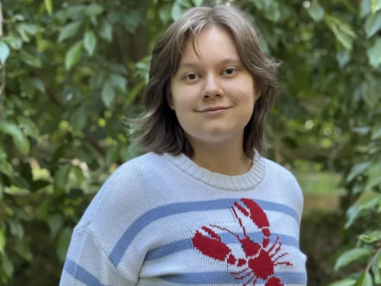 a teenage girl wearing a lobster sweater